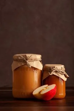 Apple jam in rustic jars with apple slice on wood table Stock Photos