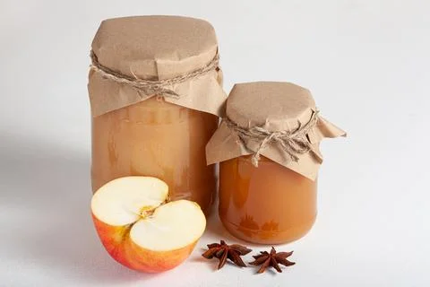 Apple jam in rustic jars with star anise and fresh apple Stock Photos