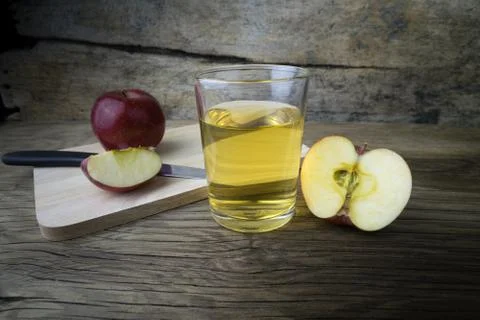 Apple juice and apples on a wooden table Stock Photos
