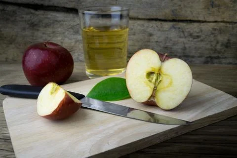 Apple juice and apples on a wooden table Stock Photos