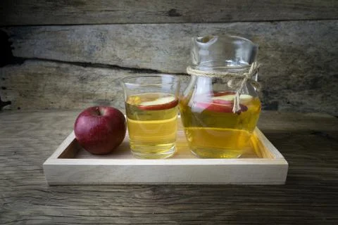 Apple juice and apples on a wooden table Stock Photos
