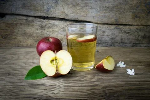 Apple juice and apples on a wooden table Stock Photos