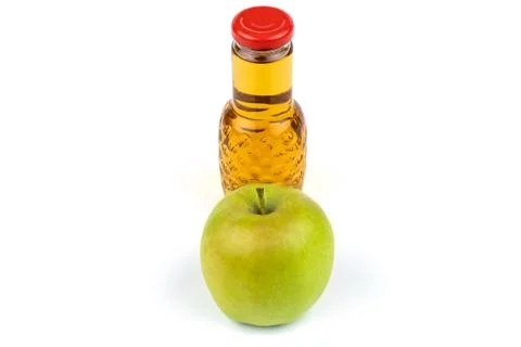 Apple juice bottle. Nearby are juicy, beautiful apples. Stock Photos