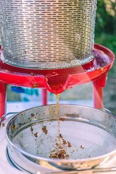 Apple juice extraction process using a hydropress strainer in a rural setti.. Stock Photos