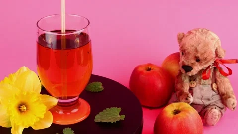 Apple juice or cider in transparent drinking glass rotate slowly on turntable in Stock Footage 194124564