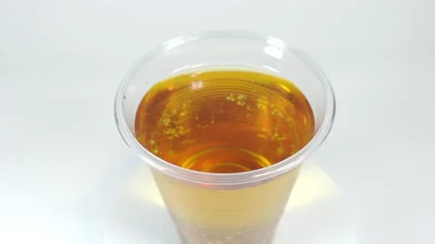 Apple juice in plastic cup Stock Footage 147906463