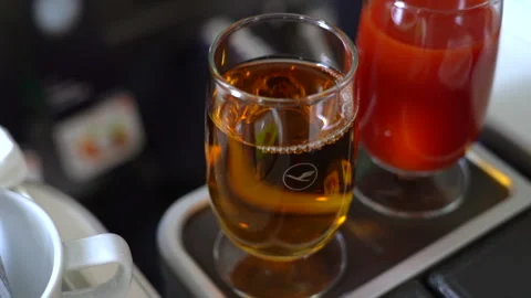 Apple juice served in a glassware on Lufthansa flight. Stockbeeldmateriaal 325761883