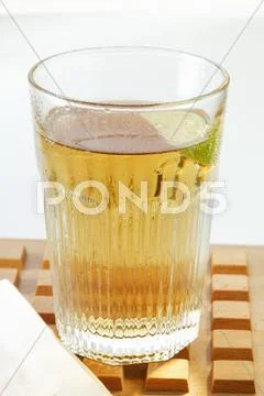 Apple juice with wedge of lime in glass Stock Photos