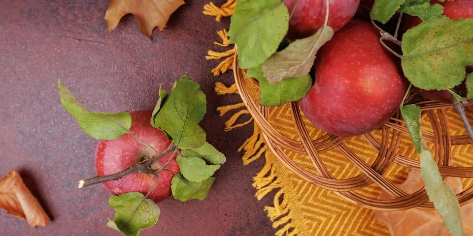 Apple with Leaves on Brown Surface Stock Photos
