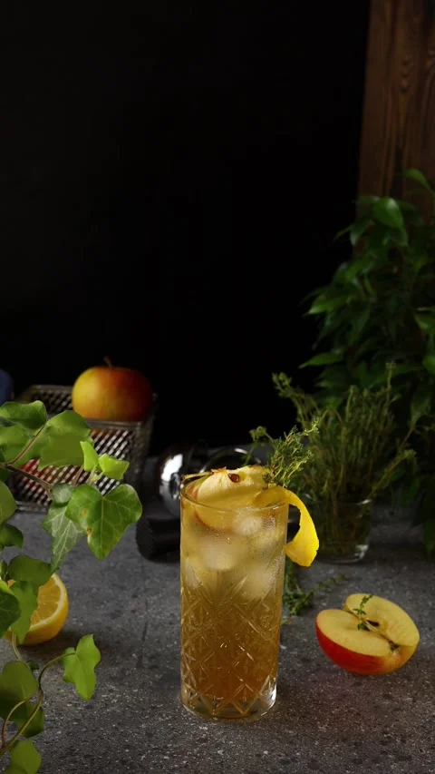 Apple lemon thyme refreshing iced tea cocktail rotating Stock Footage 333556504