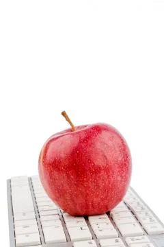 Apple lies on a keyboard Stock Photos