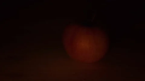 Apple in the light of a candle Stock Footage