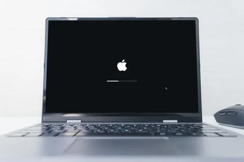 Apple logo in the screen of laptop. Stock Photos