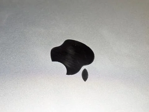 Apple Logo on Silver Laptop Surface Stock Photos