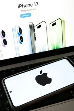 Apple logo on smartphone beside iphone 17 product page 스톡 사진
