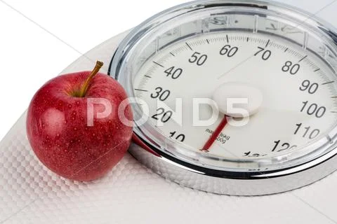 Apple lying on a balance Stock Photos