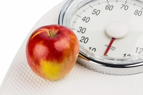 Apple lying on a balance Stock Photos