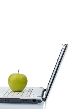Apple lying on a keyboard Stock Photos