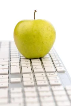 Apple lying on a keyboard Stock Photos