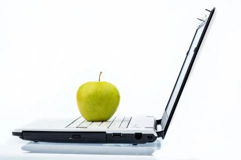 Apple lying on a keyboard Stock Photos