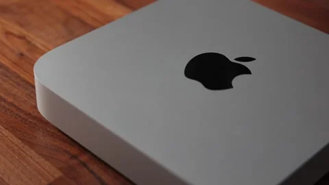 Apple Mac Mini computer in silver with logo on walnut wood desk Stock Footage 265470389