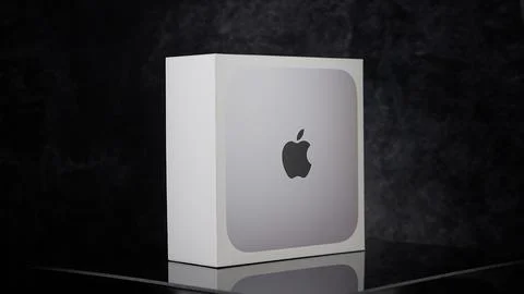 Apple Mac mini m2 pro reflecting on black surface - FRANKFURT, GERMANY - MAY 02, Stock Photos