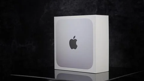 Apple Mac mini m2 pro reflecting on black surface - FRANKFURT, GERMANY - MAY 02, Stock Photos