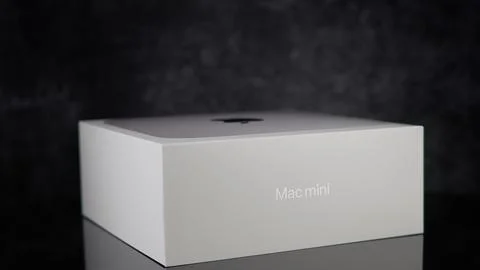 Apple Mac mini m2 pro reflecting on black surface - FRANKFURT, GERMANY - MAY 02, Stock Photos