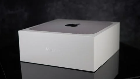 Apple Mac mini m2 pro reflecting on black surface - FRANKFURT, GERMANY - MAY 02, Stock Photos