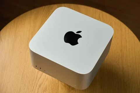Apple Mac Studio desktop computer on wooden desk Stock Photos