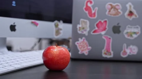 Apple MacBook and Red Apple on Desk Stock Footage 336643393