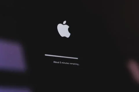 Apple macbook laptop update in progress. Updating computer mac os Stock Photos