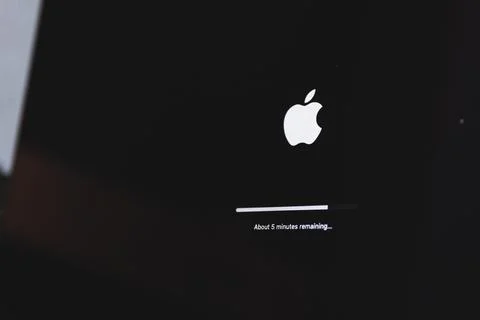 Apple macbook laptop update in progress. Updating computer mac os Stock Photos