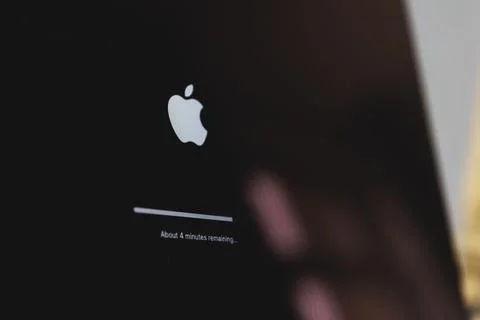 Apple macbook laptop update in progress. Updating computer mac os Stock Photos