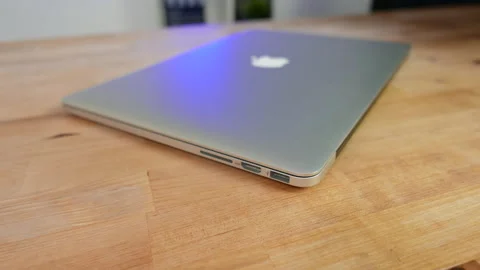 Apple MacBook Pro 15 inch laptop on wooden desk, closed. Stock Footage 237751259