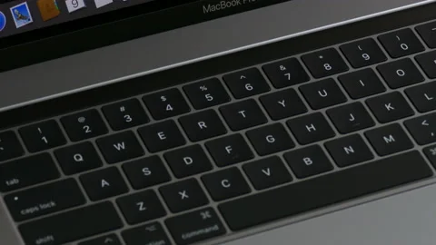 Apple MacBook Pro laptop computer close up, tilt up from keyboard to display. Stock Footage 237751849