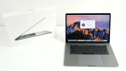 Apple MacBook Pro laptop computer and box on white desk Stock Footage 237752118