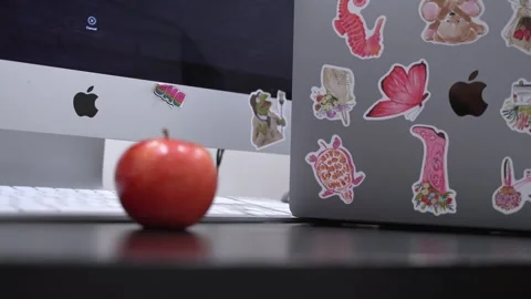Apple MacBook With Stickers Next To iMac Desktop Stock Footage 336648681