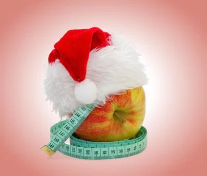 Apple with a measuring meter, in a cap santa claus Stock Photos