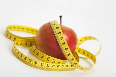 Apple with a measuring tape Stock Photos