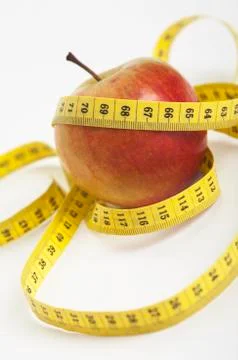 Apple with a measuring tape Stock Photos