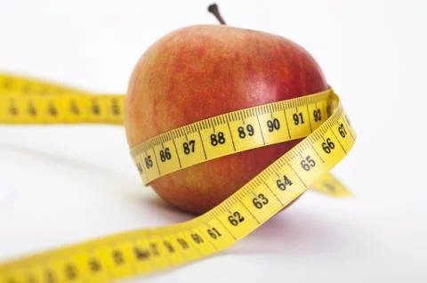 Apple with a measuring tape 库存照片