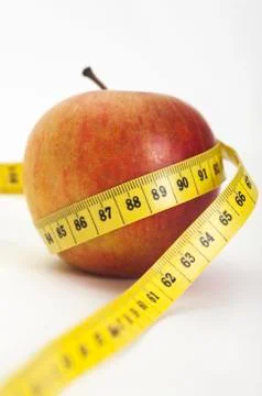 Apple with a measuring tape 库存照片