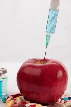 Apple with needle Stock Photos