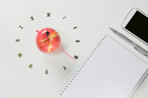The apple with number of clock and smart phone, apple shape clock on white ba Stock Photos