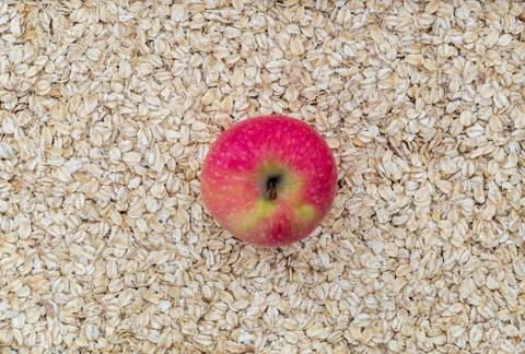 Apple on oatmeal as background Stock Photos