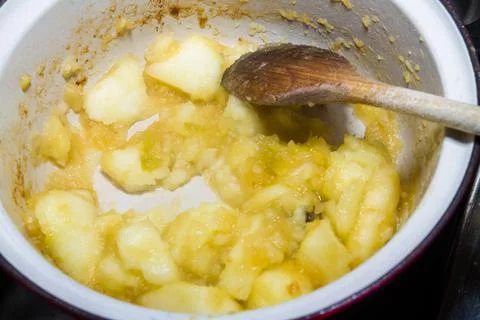Apple in pan being cooked to make apple sauce. Stock Photos