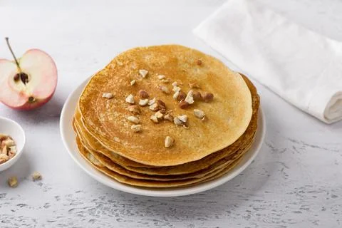 Apple pancakes with nuts on a light gray background, top view. Delicious Stock Photos