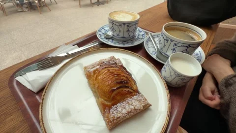 Apple Pastry and Coffee Served on Cafe Table with Person Seated Indoors Stock Footage 341835395