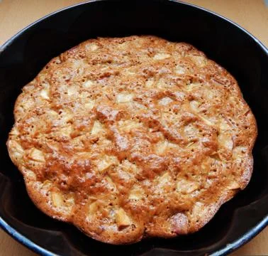 Apple pie in a baking dish on the table Stock Photos
